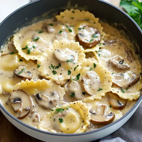 A bowl of pasta with mushrooms and herbs.
